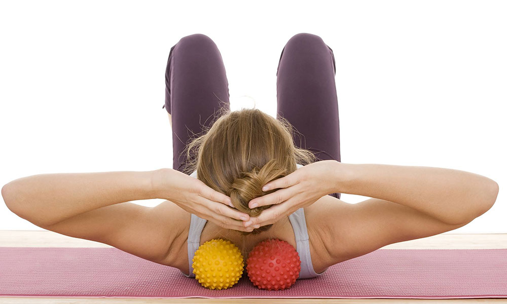 women doing physio stretches on exercise ball